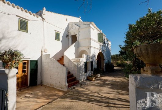 Dans la campagne minorquine, aux abords de Ciutadella, une ancienne ferme à arcs de pierre avec un étage indépendant ...